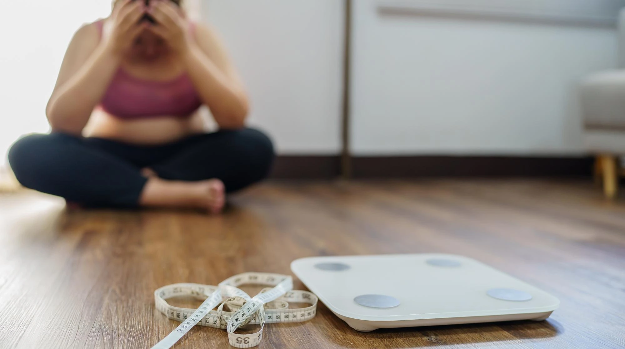 Woman feeling stressed and stuck on a weight loss plateau in Atlanta